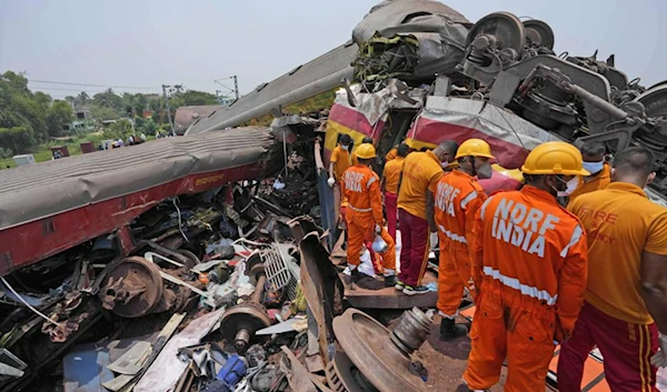 Rescuers work at the site of passenger trains that derailed in Balasore district, in the eastern Indian state of Orissa, Saturday, June 3, 2023. (AP)