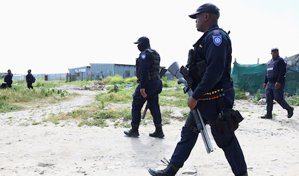 Law enforcement officers operate at the Marikana, Cape Town, South Africa, October 12 2022. (Reuters)