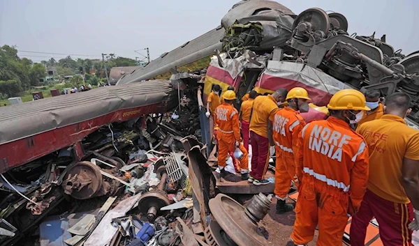 Rescuers work at the site of passenger trains that derailed in Balasore district, in the eastern Indian state of Orissa, Saturday, June 3, 2023. (AP)