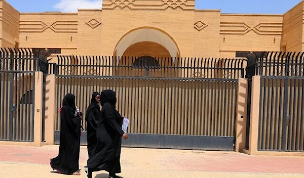 Women walk past the closed Iranian embassy in the diplomatic quarter of the Saudi capital Riyadh, on April 11, 2023 (AFP)