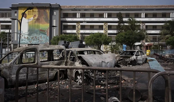 Burned cars are seen at the entrance of the Cheikh Anta Diop University after authorities ordered the institution to be closed until further notice in Dakar, Senegal, Friday, June 2, 2023. (AP)