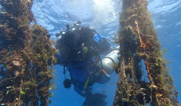 A diver retrieves a 'ghost net' from the seabed off the Greek island of Santorini (AFP)