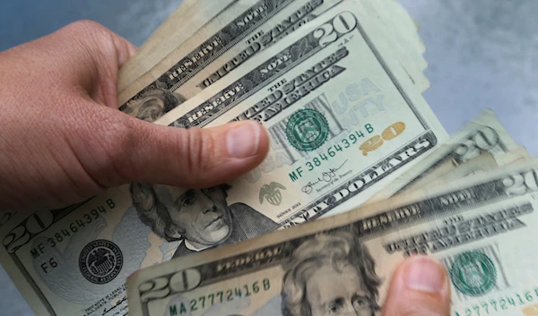 In this June 15, 2018 photo, twenty dollar bills are counted in North Andover, Mass (AP Photo/Elise Amendola, File)