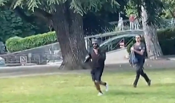 A screenshot from video of the attack showing the assailant being chased by another man in Annecy. (AFP)