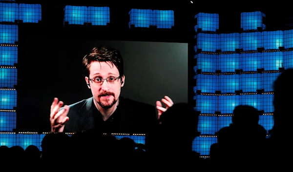 Former U.S. National Security Agency contractor Edward Snowden addresses attendees through video link at the Web Summit technology conference in Lisbon on Nov. 4, 2019  (AP Photo/Armando Franca, File)