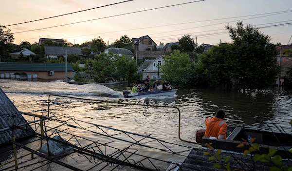 Volunteers conduct evacuations from a flooded neighborhood in Kherson, Wednesday, June 7, 2023. (AP)