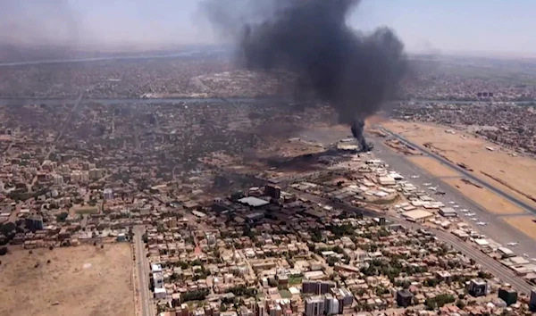 An aerial view shows black smoke rising above the Khartoum International Airport in Khartoum, Sudan, on April 20, 2023. (AFP)