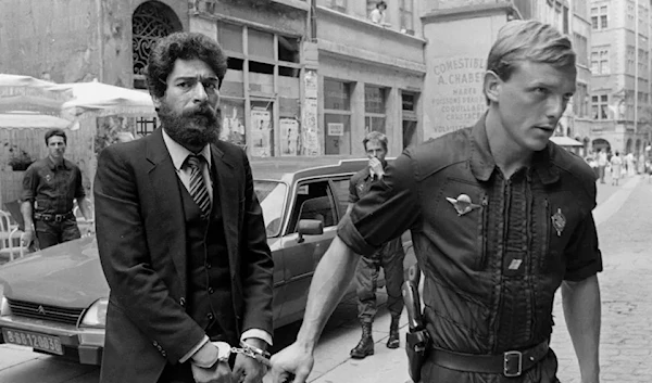 File photo shows Lebanese Armed Revolutionary Factions (LARF) activist George Ibrahim Abdallah escorted by a French Gendarme as he arrives at Lyon courthouse, July 10, 1986 (samidoun network)