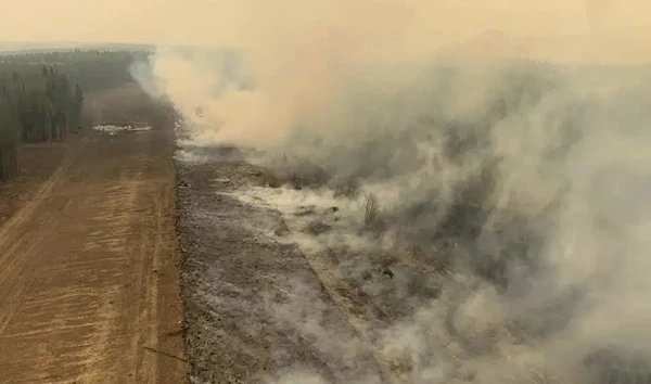 In this photo provided by the Government of Alberta Fire Service, a burned section of forest in the area near Edson, Alberta, smolders, Saturday, May 6, 2023. (Government of Alberta Fire Service/The Canadian Press via AP)