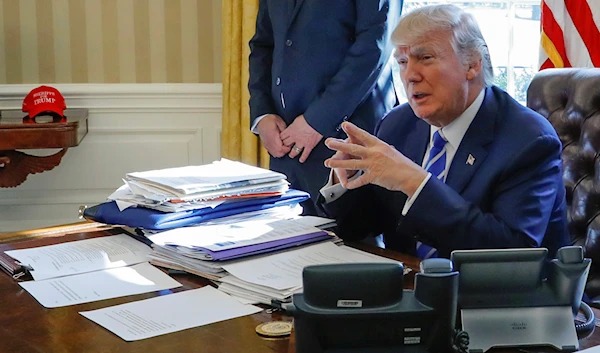 Then-President Donald Trump sits at his desk after a meeting with Intel CEO Brian Krzanich in the Oval Office of the White House in Washington, February 8, 2017 (AP)