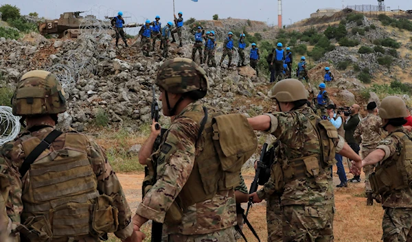 Lebanese troops and UN peacekeepers deploy along a fence at Lebanon's southern border with Syria in the disputed Kfar Chouba hills, June 9, 2023 (AP)