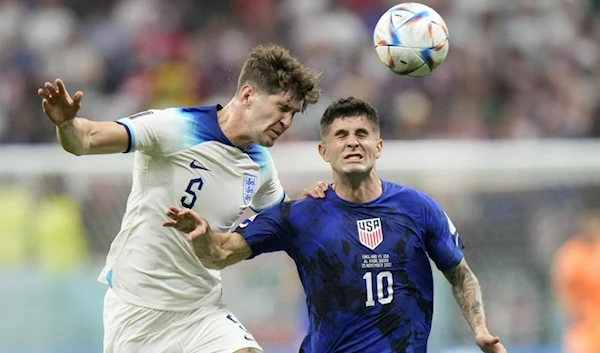 England's John Stones vies for the ball with Christian Pulisic of the United States, right, during the World Cup group B soccer match between England and The United States, at the Al Bayt Stadium in Al Khor , Qatar, Friday, Nov. 25, 2022. (AP)