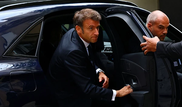 French President Emmanuel Macron exits a car to arrive to an inter ministerial crisis unit meeting after French police murdered Nahel M. in cold blood, Paris, France, 30 June 2023. (AFP)