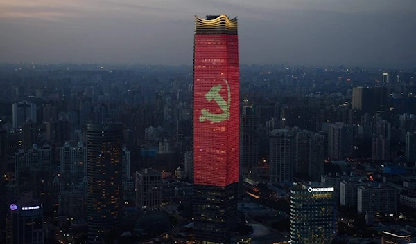 Emblem of the Chinese Communist Party displayed on a sky scraper in Shanghai August 31 2021 (AFP)