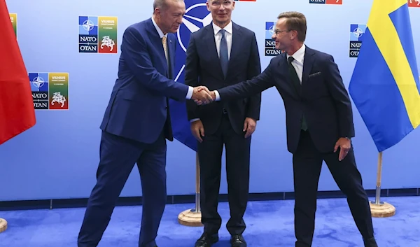 Turkish President Recep Tayyip Erdogan shakes hands with Sweden's Prime Minister Ulf Kristersson at the NATO summit in Vilnius, Lithuania. (AP)