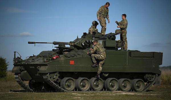 British military personnel mount an a Warrior infantry fighting vehicle during a live fire combat training with Ukrainian recruits near Durrington, UK, October 11 2022. (AFP)