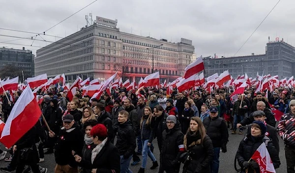 Poles carrying national flags in Warsaw. (AFP)