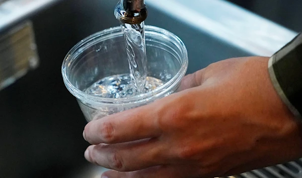 A cup of water is drawn from a faucet at Johnny T's Bistro and Blues, a midtown Jackson, Miss., restaurant and entertainment venue on Sept. 1, 2022. (AP)