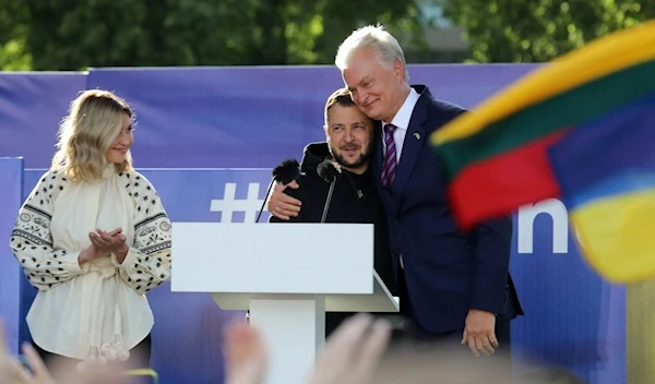 Ukrainian President Volodymyr Zelensky (centre) gets a hug by Lithuania's President Gitanas Nauseda after addressing the crowd at Lukiskiu Square in Vilnius on July 11, 2023, during a NATO Summit. (AFP)