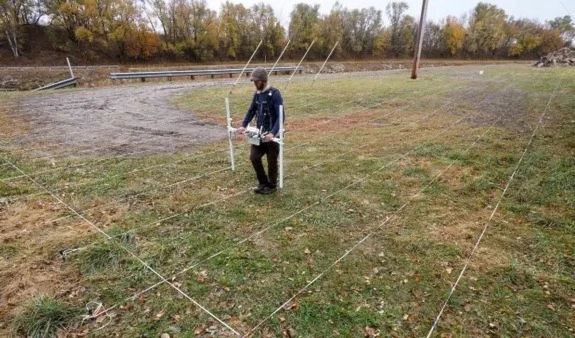 A searcher uses ground-penetrating radar at the former Genoa Indian industrial school where more than 80 Native American children are thought to be buried. (AP)