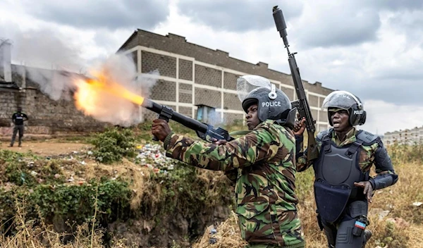 A Kenya Police Officer shoots a tear gas canister to disperse some protesters as they gather to demonstrate in Nairobi, Kenya on July 12, 2023 (AFP)