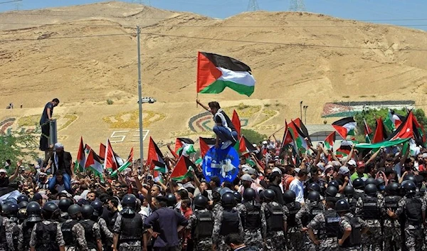 Jordanian protesters demonstrate in solidarity with Palestinians, in the town of Karameh, on the border with Occupied Palestine, on May 14, 2021 (AFP)