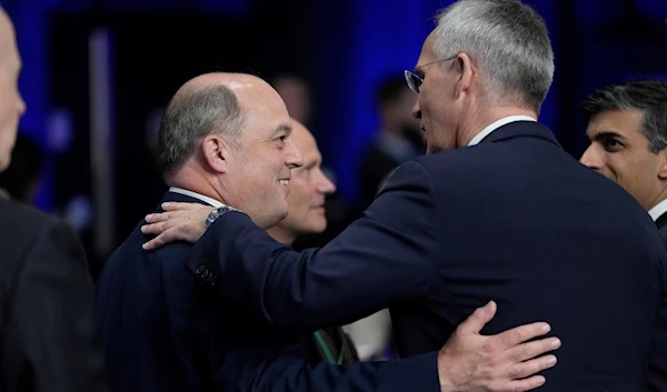 British Defense Secretary Ben Wallace, left, speaks with NATO Secretary General Jens Stoltenberg during a NATO summit in Vilnius, Lithuania, July 12, 2023 (AP)