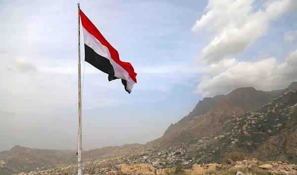 A Yemeni flag waves in the city of Taez (AFP)