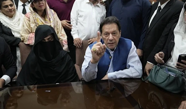 Pakistan's former Prime Minister, Imran Khan, talks to the media before signing the documents to submit surety bond over his bails in different cases, in Lahore Gigh Court in Lahore, on July 17, 2023. (AP)