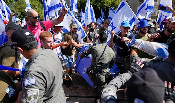 Israelis protest against plans by Prime Minister Benjamin Netanyahus government to overhaul the judicial system scuffle with police in Tel Aviv, Israel, Tuesday, July 18, 2023. (AP)