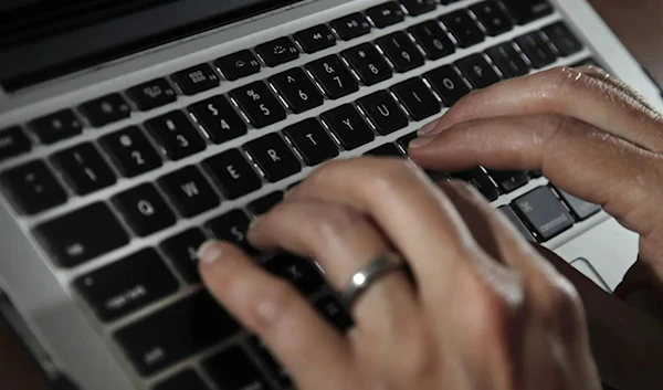 A person types on a laptop keyboard in North Andover, Mass, June 19, 2017. (AP)