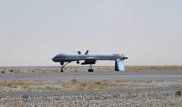 In this June 13, 2010, file photo a U.S. Predator unmanned drone armed with a missile stands on the tarmac of Kandahar military airport in Afghanistan (AP Photo/Massoud Hossaini, Pool, File)