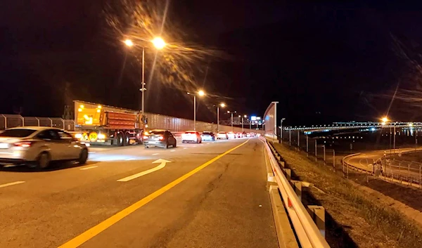 Cars drive on the Crimean Bridge connecting Russian mainland and Crimean peninsula over the Kerch Strait after opening a reverse traffic in Krasnodar region of south Russia, July 18, 2023.