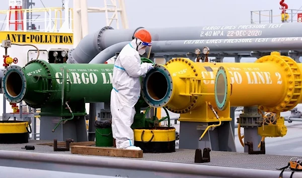 An inspection officer checks a tanker carrying imported crude oil at Qingdao port in China's eastern Shandong province, May 9, 2022 (AFP)