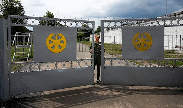 A Belarus' Army soldier closes the gate of the Belarusian army camp near Tsel village, about 90 kilometers (about 55 miles) southeast of Minsk, Belarus, July 7, 2023 (AP)