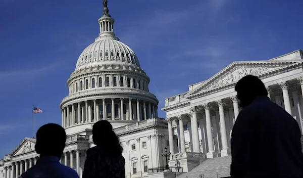 People walk outside the U.S. Capitol building in Washington on June 9, 2022. (AP)