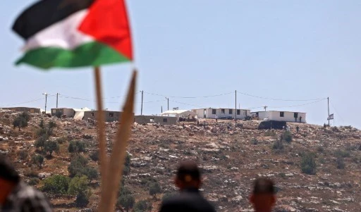 Palestinian protesters attend a demonstration against the Evyatar settlement outpost, south of Nablus, on June 4, 2021, in the West Bank. (AFP)