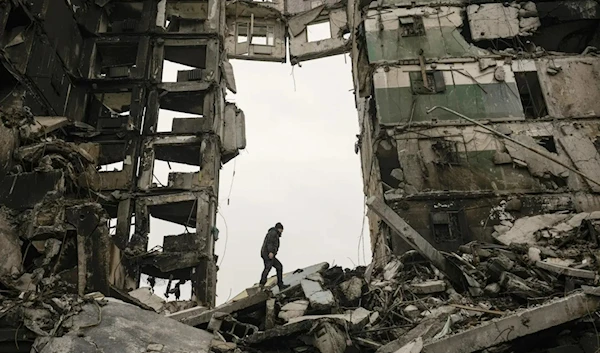 A resident looks for belongings in an apartment building destroyed during the fight between Russian and Ukrainian forces in Borodyanka, April 5, 2022. (AP)