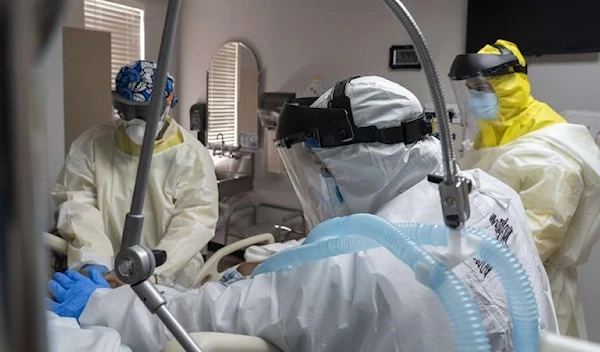 Members of the medical staff treat a patient in the COVID-19 intensive care unit in Houston, Texas. (AFP)