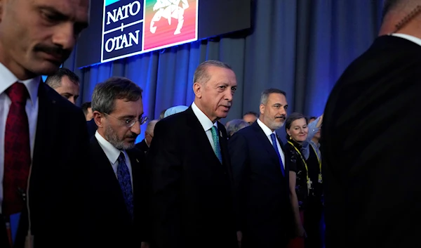 Turkish President Recep Tayyip Erdogan, center, leaves after addressing a media conference at a NATO summit in Vilnius, Lithuania, July 12, 2023 (AP)