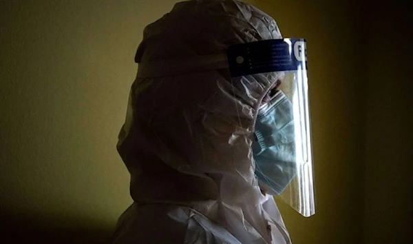 A medic watches a Covid-19 patient hospitalized at the Covid-19 Intensive Care Unit of the Pulmonology department of the Hospital Ruzinov in Bratislava, Slovakia on February 24, 2021. (AFP via Getty Images)