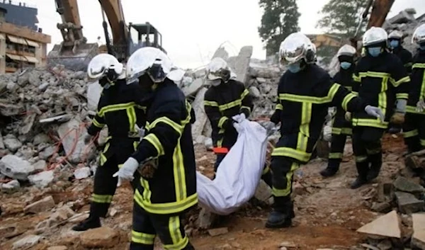 A file photo shows rescuers holding a person killed in a collapse (AFP Africa)