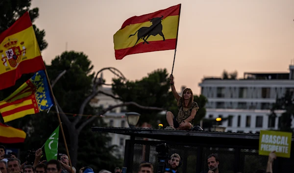 VOX far right supporters wave Spanish flags during the closing campaign rally at the Colon square in Madrid, Spain, Friday, July 21, 2023. (AP)