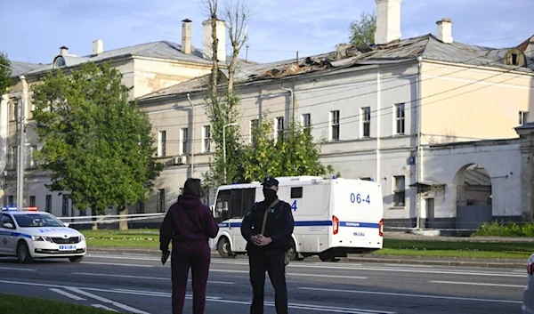 A police officer secures an area outside a damaged non-residential building on Komsomolsky Prospekt after a reported drone attack in Moscow on July 24, 2023 (AFP)