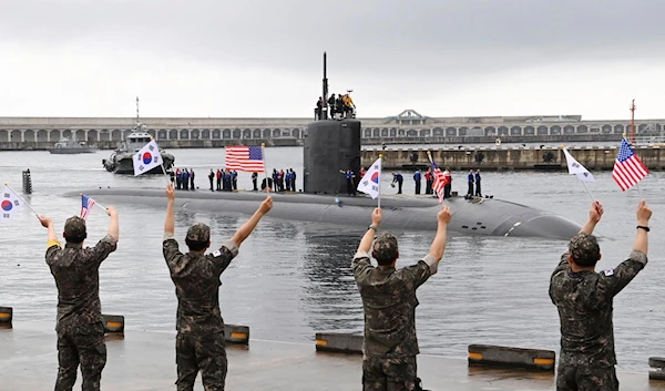 In this photo provided by South Korea Defense Ministry, South Korean navy sailors wave as the USS nuclear-powered submarine USS Annapolis arrives at a South Korean naval base on Jeju Island, South Korea, Monday, July 24, 2023. (AP)