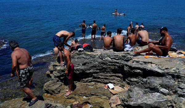 People cool down on a sweltering hot day at the Mediterranean Sea in Beirut, Lebanon, Sunday, July 23, 2023. (AP)