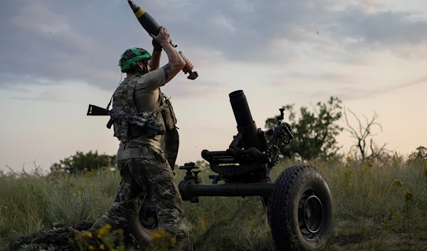 A Ukrainian troop of the 3rd Assault Brigade fires a 122mm mortar towards Russian positions at the front line, near Bakhmut, Donetsk, July 2, 2023 (AP)