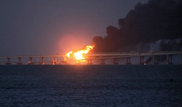 Flame and smoke rise from the Crimean Bridge connecting the Russian mainland and Crimea over the Kerch Strait, in Kerch, Crimea, Oct. 8, 2022 (AP)