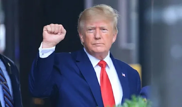 Former US President Donald Trump raises his fist while walking to a vehicle outside of Trump Tower in New York City on August 10, 2022. (AFP via Getty Images)