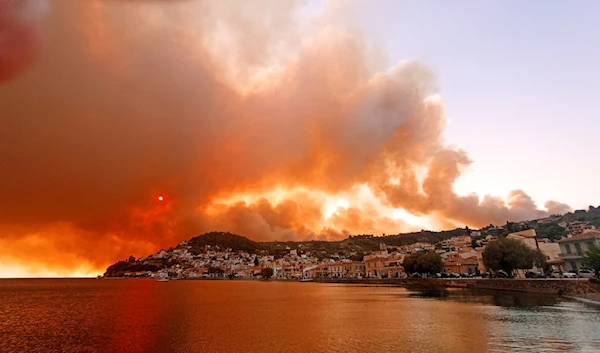 Flames burn on the mountain near Limni village on the island of Evia, about 160 kilometers (100 miles) north of Athens, Greece, Tuesday, Aug. 3, 2021. (AP)